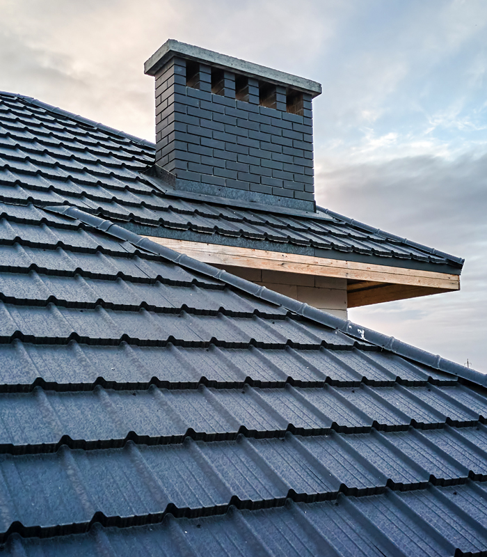 http://Tiled%20roof%20and%20chimney%20on%20a%20residential%20building%20in%20Mount%20Vernon,%20Westchester%20County,%20serviced%20by%20Western%20Family%20Solutions%20LLC,%20experts%20in%20Mount%20Vernon%20Roofing.