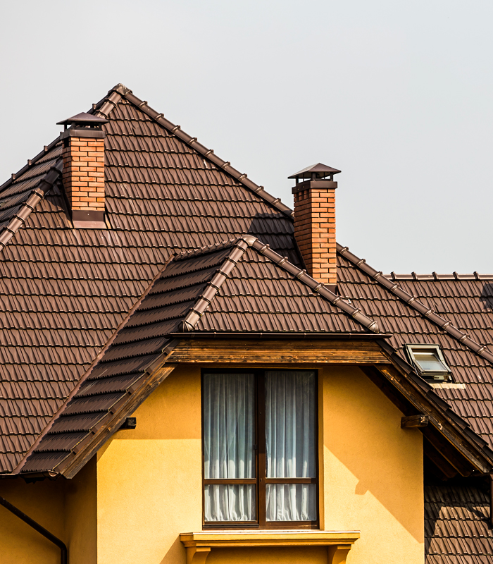 http://Tile-roofed%20residential%20building%20with%20two%20chimneys%20and%20a%20skylight%20in%20New%20Rochelle,%20Westchester%20County,%20serviced%20by%20Western%20Family%20Solutions%20LLC,%20experts%20in%20New%20Rochelle%20Roofing.
